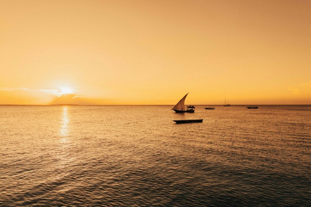 Sailboat on a calm sea at sunset